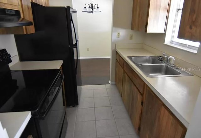 kitchen with sink, extractor fan, light tile floors, and black / electric stove