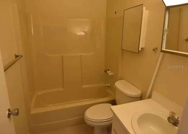 full bathroom with large vanity, toilet, and shower / washtub combination