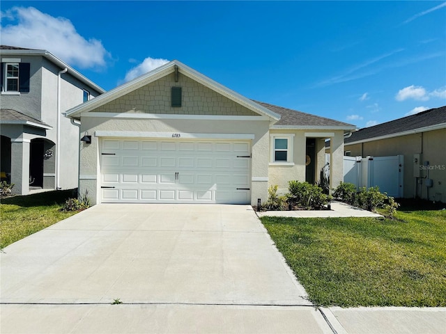 view of front of property featuring a garage and a front lawn