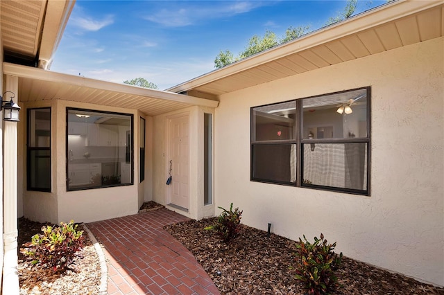 view of exterior entry with stucco siding