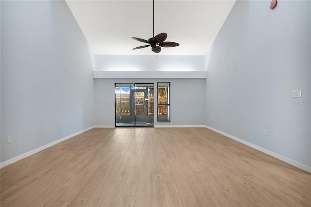 spare room with ceiling fan, light wood finished floors, and baseboards