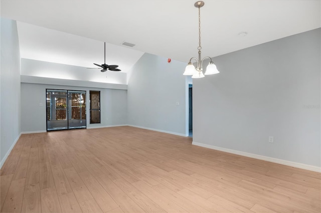 unfurnished room with visible vents, light wood-style flooring, baseboards, and ceiling fan with notable chandelier