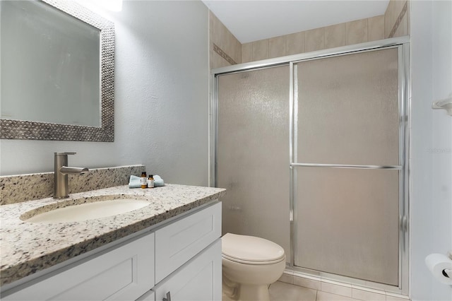 bathroom with toilet, a shower stall, and vanity