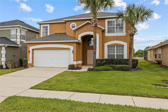 view of front of home with a front lawn and a garage