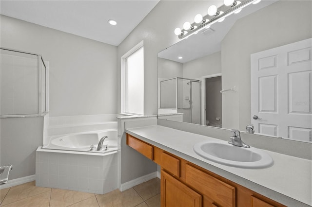 bathroom featuring large vanity, separate shower and tub, and tile flooring