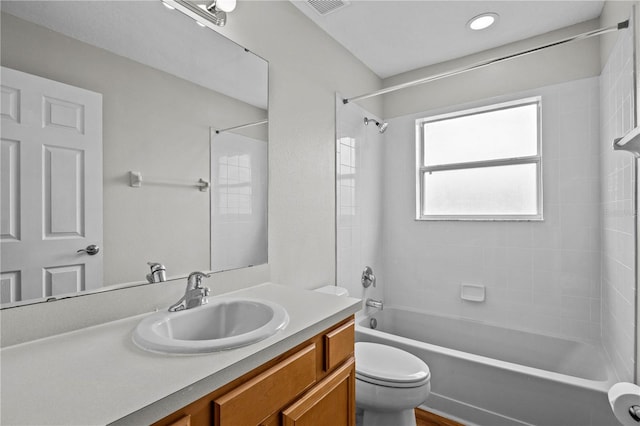 full bathroom featuring oversized vanity, toilet, and tiled shower / bath