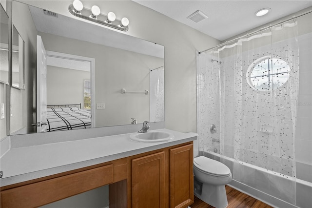 full bathroom featuring a healthy amount of sunlight, wood-type flooring, vanity, shower / tub combo with curtain, and toilet