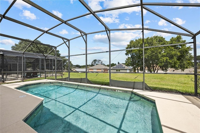 view of swimming pool with a patio area, a yard, and glass enclosure