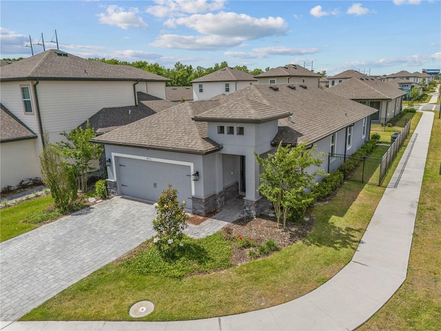 view of front of property featuring a front lawn and a garage