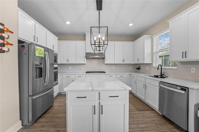 kitchen with hardwood / wood-style floors, tasteful backsplash, and stainless steel appliances