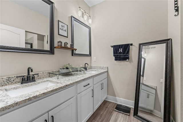 bathroom featuring hardwood / wood-style flooring and double vanity