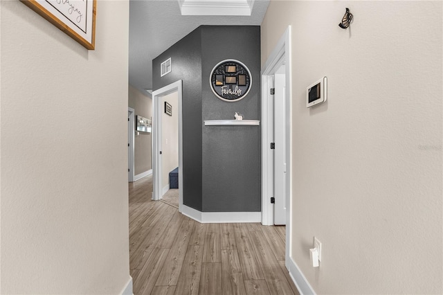 hallway with light hardwood / wood-style floors