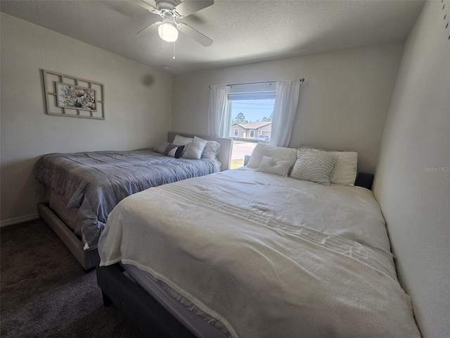 bedroom featuring dark colored carpet and ceiling fan