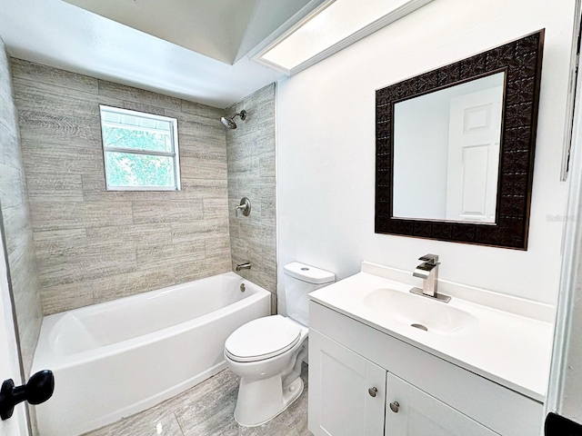 full bathroom featuring vanity, toilet, and tiled shower / bath