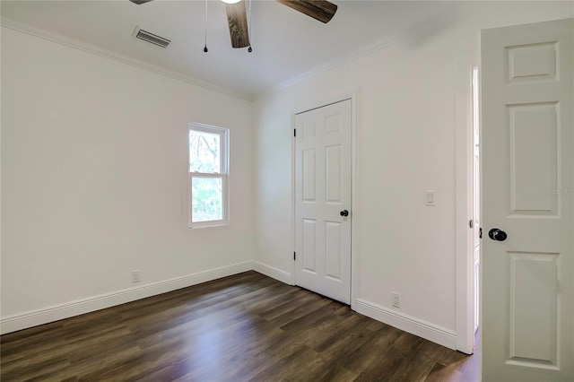 unfurnished bedroom with dark hardwood / wood-style floors, ceiling fan, and ornamental molding