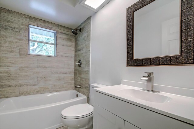 full bathroom with vanity, toilet, and tiled shower / bath combo