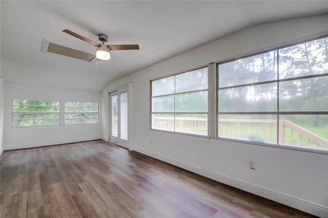 spare room with hardwood / wood-style flooring, vaulted ceiling, and ceiling fan