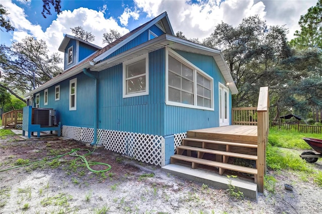 view of property exterior featuring cooling unit and a deck