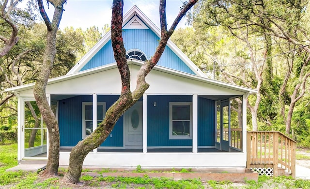 back of house featuring a sunroom