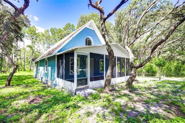 view of side of home featuring a sunroom