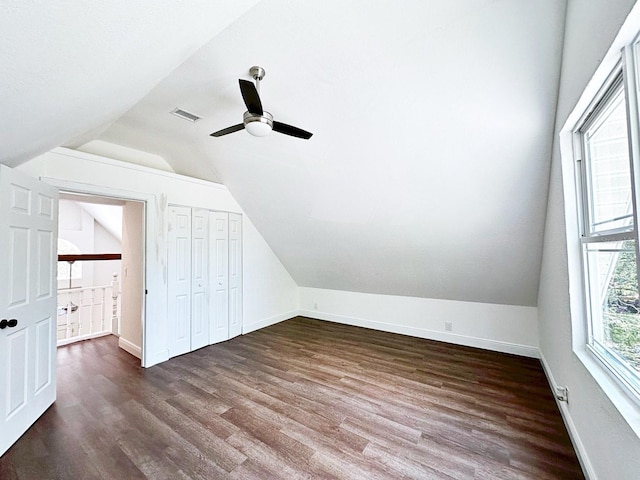 additional living space with dark wood-type flooring, vaulted ceiling, and ceiling fan