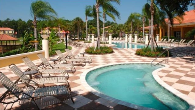 view of swimming pool with a patio