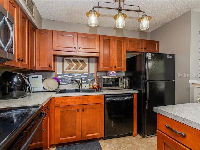 kitchen with light tile flooring, black appliances, sink, tasteful backsplash, and a textured ceiling