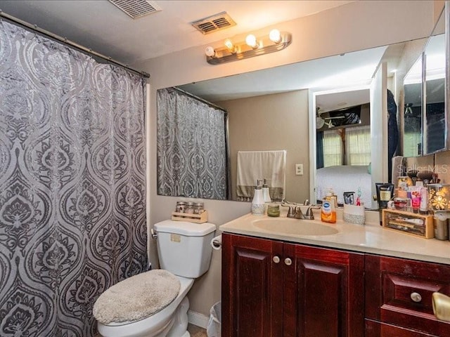 bathroom with toilet and vanity