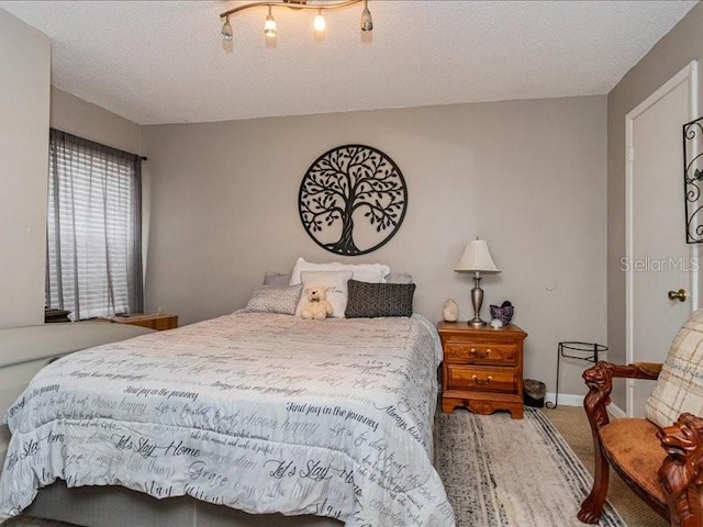 bedroom featuring carpet and a textured ceiling