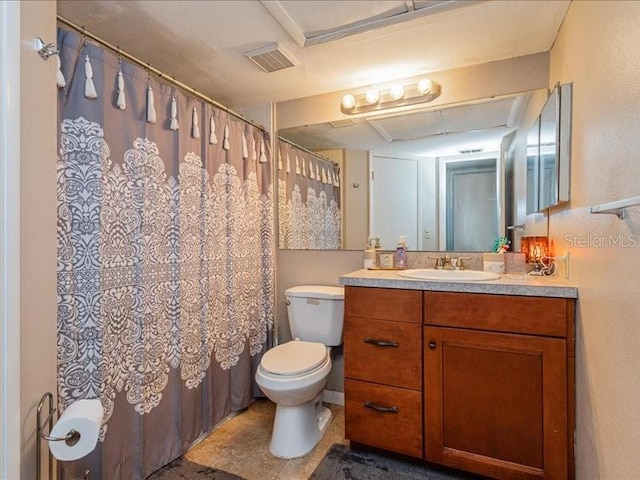 bathroom featuring tile floors, toilet, and large vanity