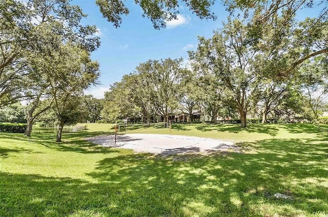 view of home's community with a yard and volleyball court