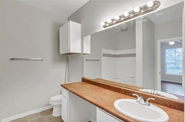 bathroom featuring vanity, tile floors, and toilet