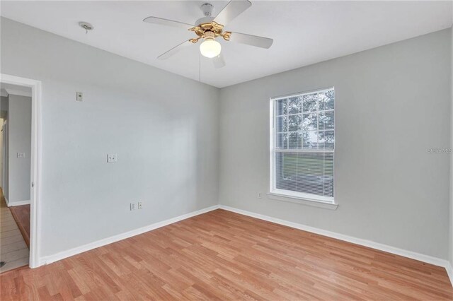 empty room with light hardwood / wood-style flooring and ceiling fan