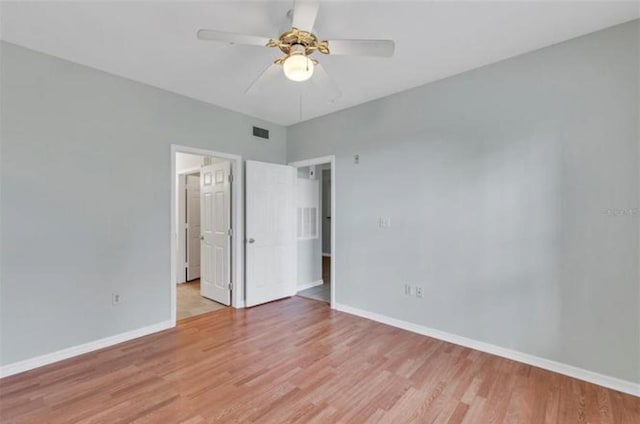 spare room with wood-type flooring and ceiling fan