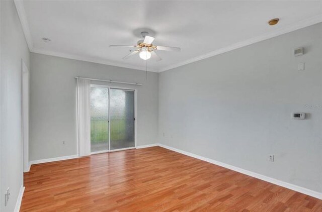 spare room with ornamental molding, ceiling fan, and light wood-type flooring