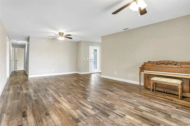 unfurnished living room featuring ceiling fan and hardwood / wood-style flooring