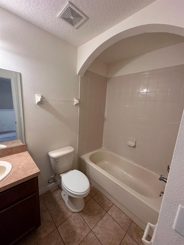 full bathroom with toilet, tile flooring, a textured ceiling, vanity, and bathtub / shower combination