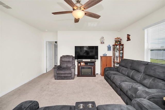 carpeted living room with ceiling fan