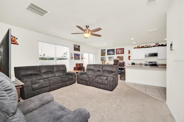 carpeted living room with ceiling fan