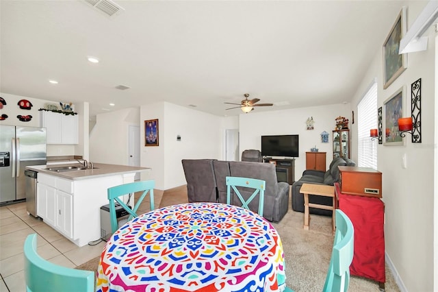 dining room with sink, ceiling fan, and light tile floors