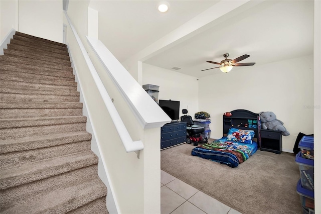 bedroom with ceiling fan and tile floors