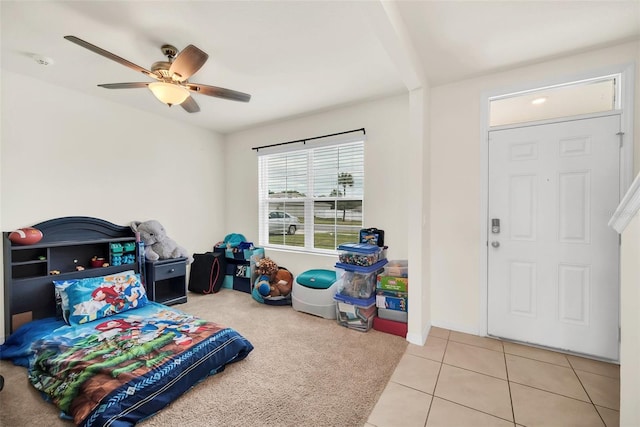 playroom with ceiling fan and light tile flooring