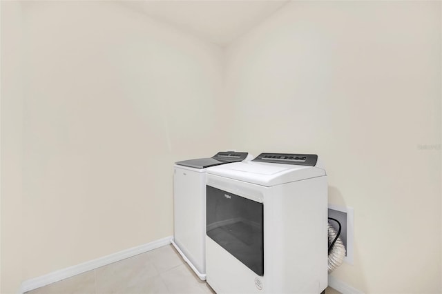 laundry area featuring washer hookup, washing machine and clothes dryer, and light tile floors