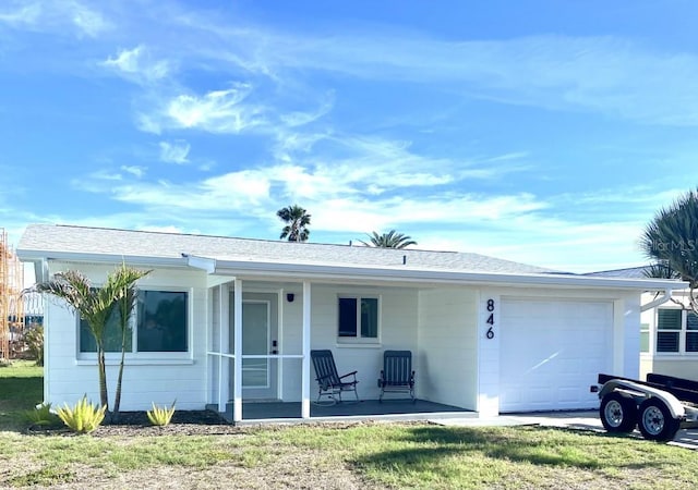 single story home featuring a garage and covered porch