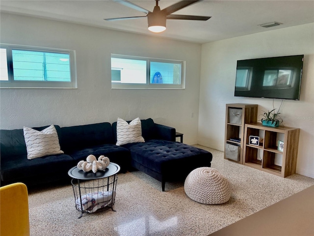 living room featuring plenty of natural light, ceiling fan, and visible vents