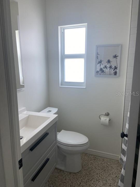 bathroom featuring vanity and toilet