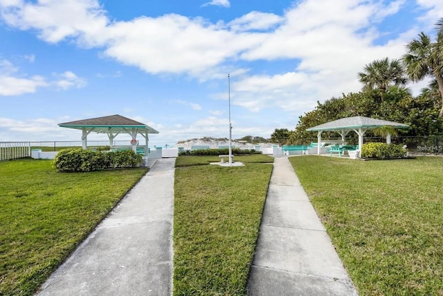 exterior space with a swimming pool, a yard, and a gazebo