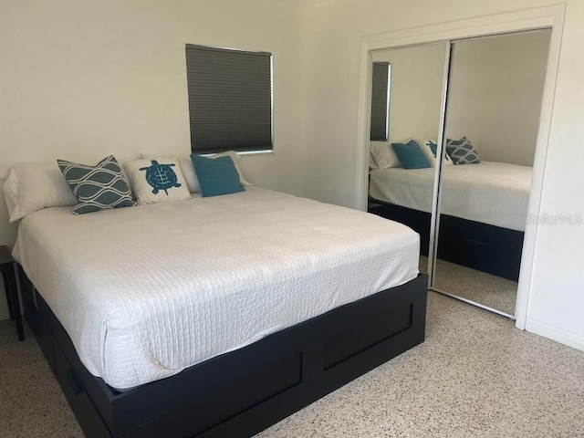 bedroom featuring a closet and speckled floor