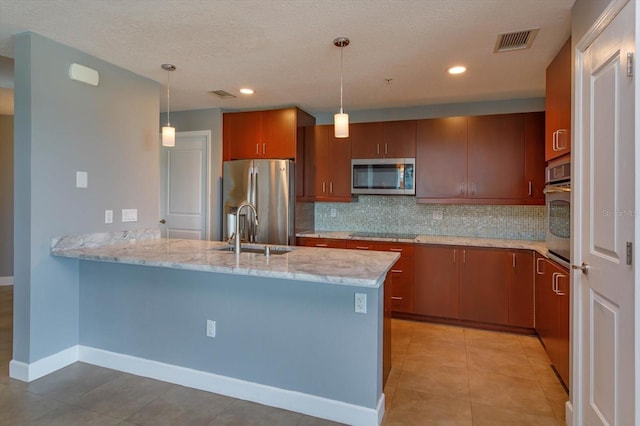 kitchen featuring light tile floors, sink, decorative light fixtures, stainless steel appliances, and kitchen peninsula