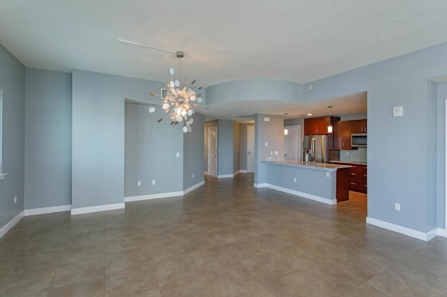 unfurnished living room with a chandelier and tile floors